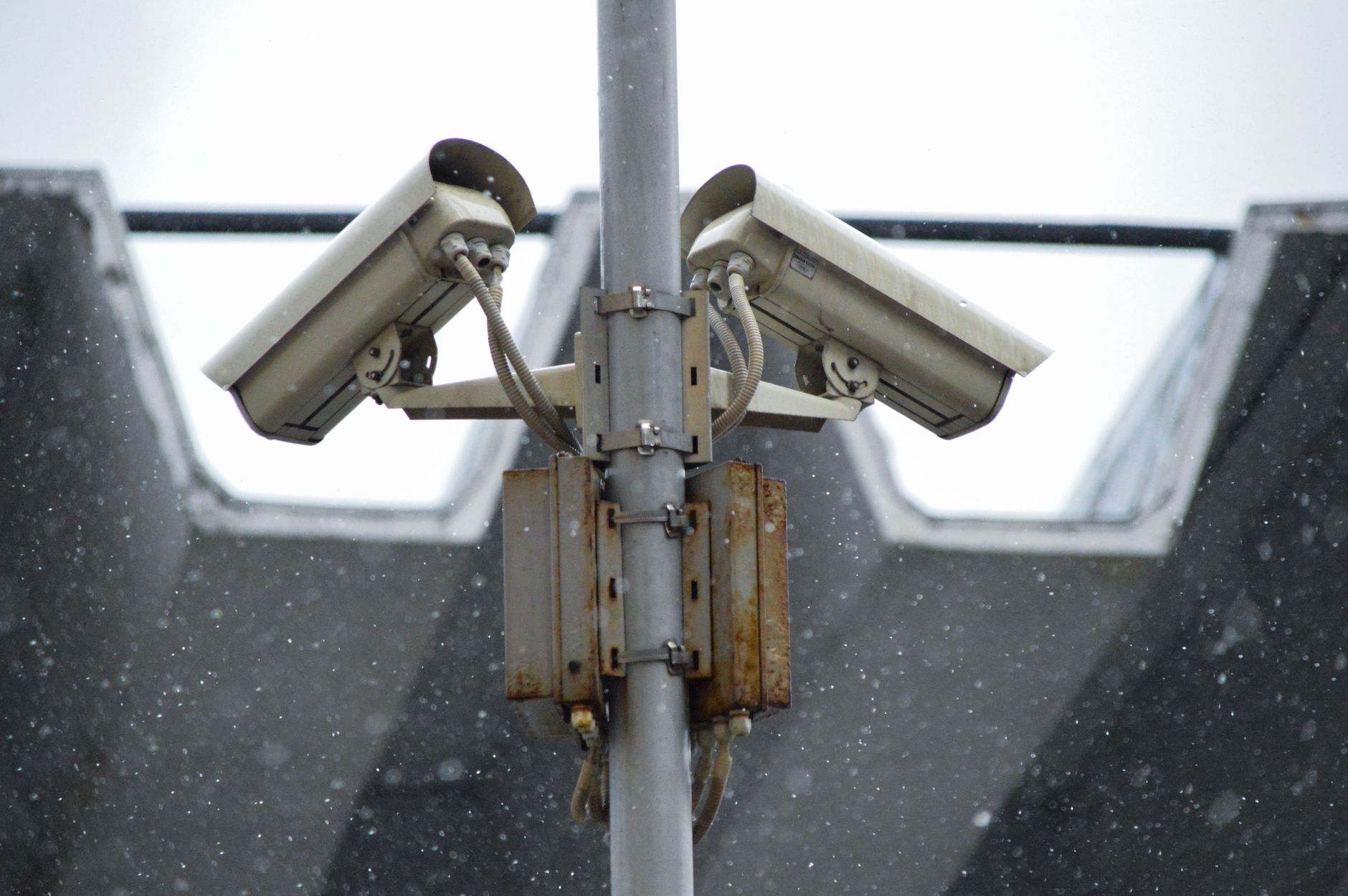 Close-up of a surveillance camera on a UK town centre building, relevant to ANPR cameras UK councils deploy