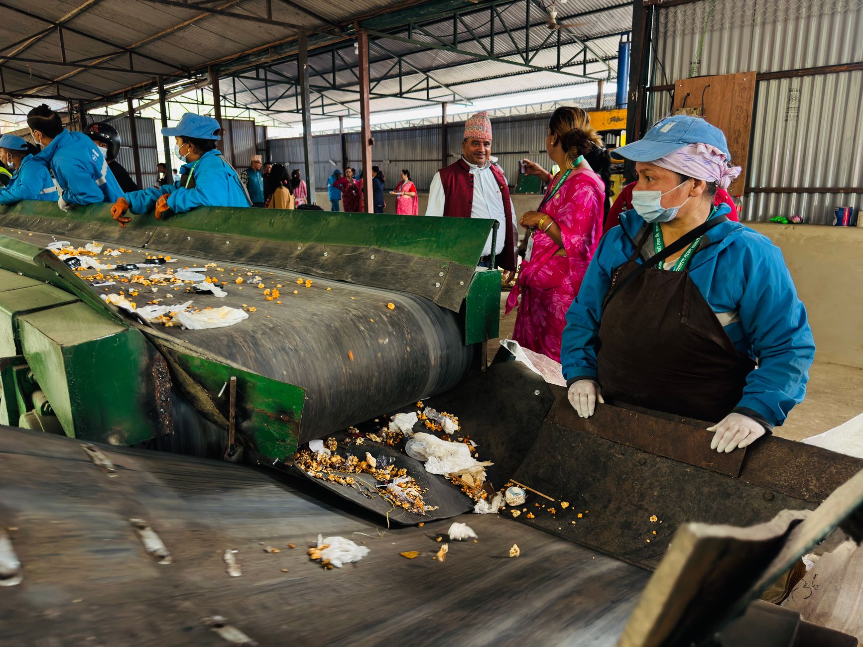 Worker sorting materials at a recycling centre skip bay as councils review household waste recycling centre charges UK